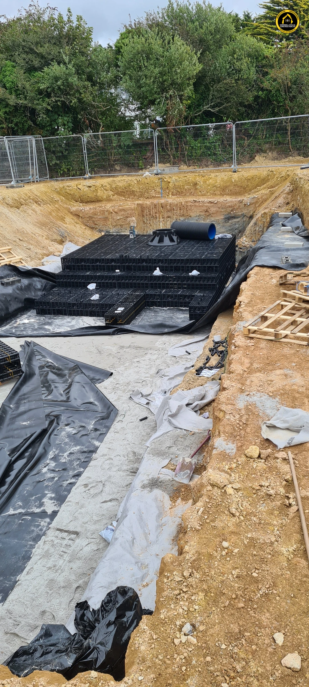 Attenuation crates and geotextile in a large excavation in Goonhavern
